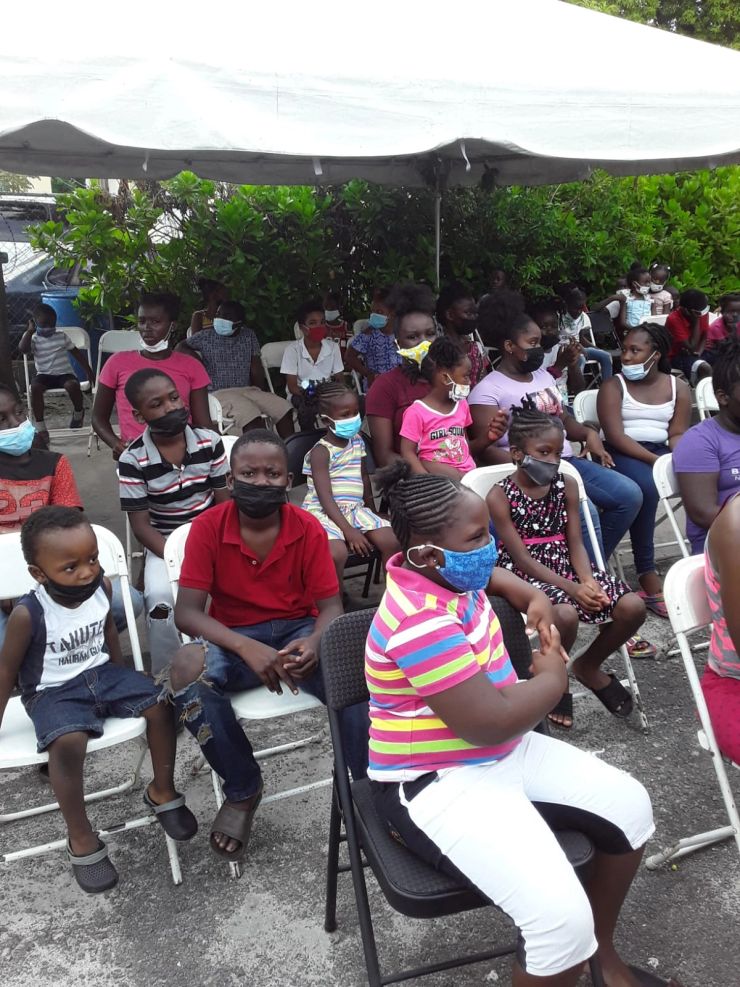 Children and families gathered under the Big Harvest tent