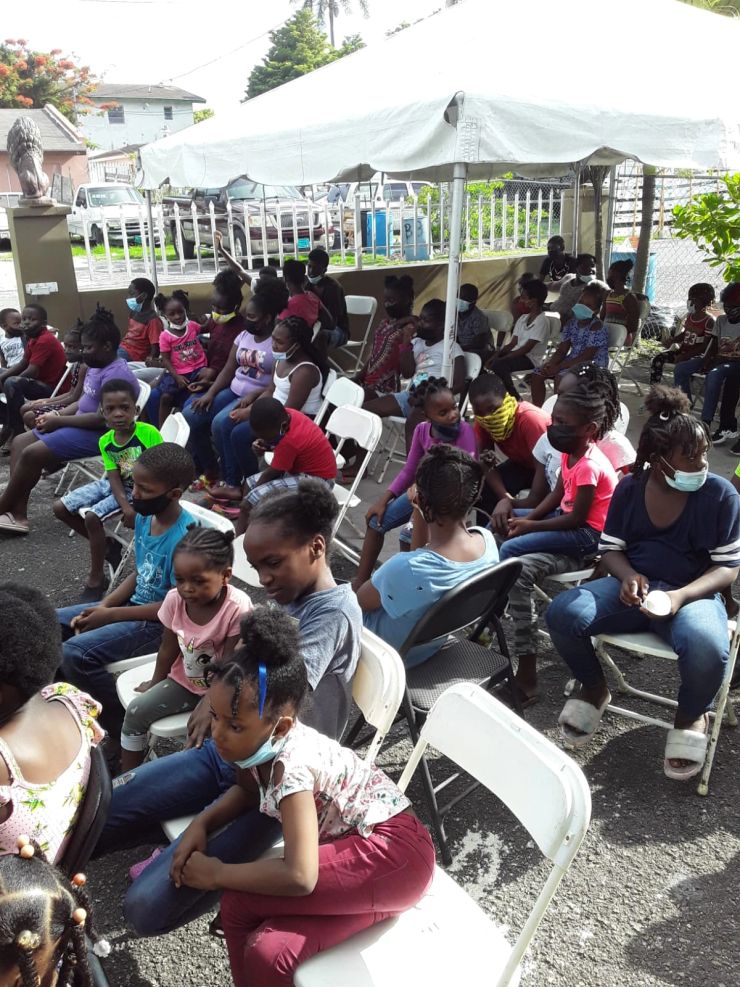 A community gathering beneath the tent